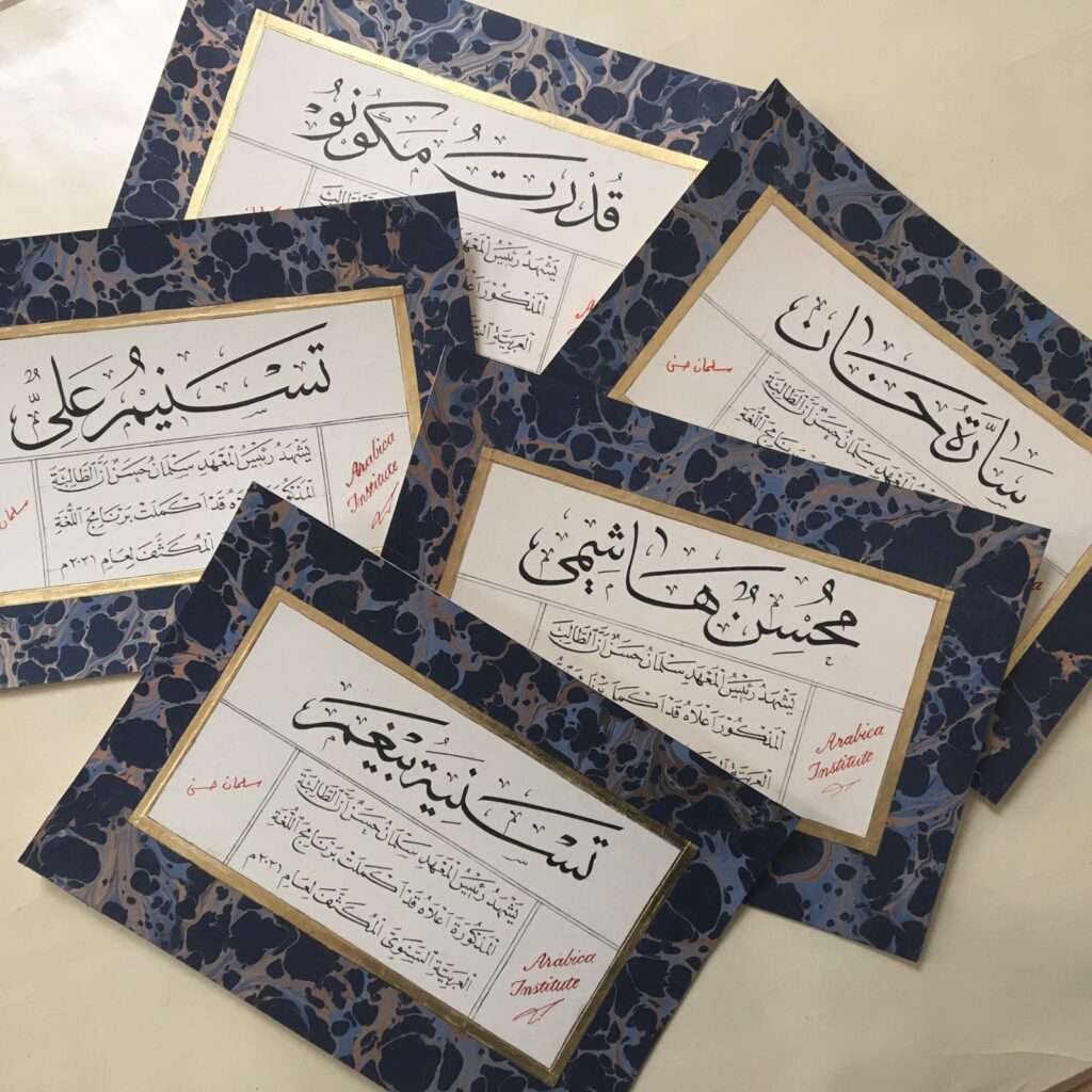 Hand written graduation certificates on marbled ebru paper with gold rules