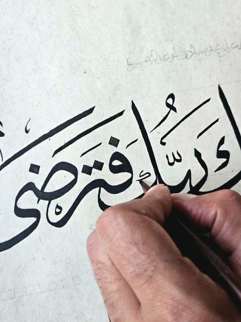 Rizwan Khan lettering Thuluth with a reed qalam over pencil guidelines